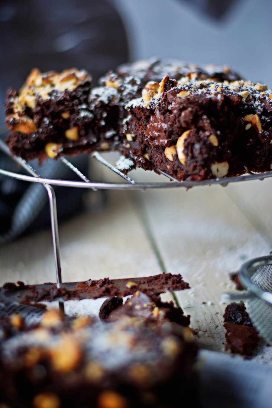 Closeup view to one of the Salted-Cashew Orange-Cranberry Brownies, showing the gooey chocolate inside.