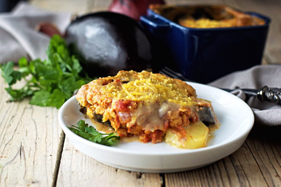 One partion of the creamy vegan Moussaka on a small white plate.