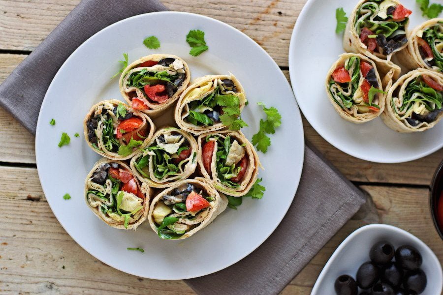 Top view of several plates with the Mediterranean Pinwheels ready for serving.