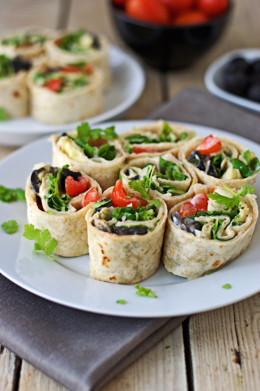 Closeup of a Mediterranean Pinwheel showing the vegetable and salad filling.