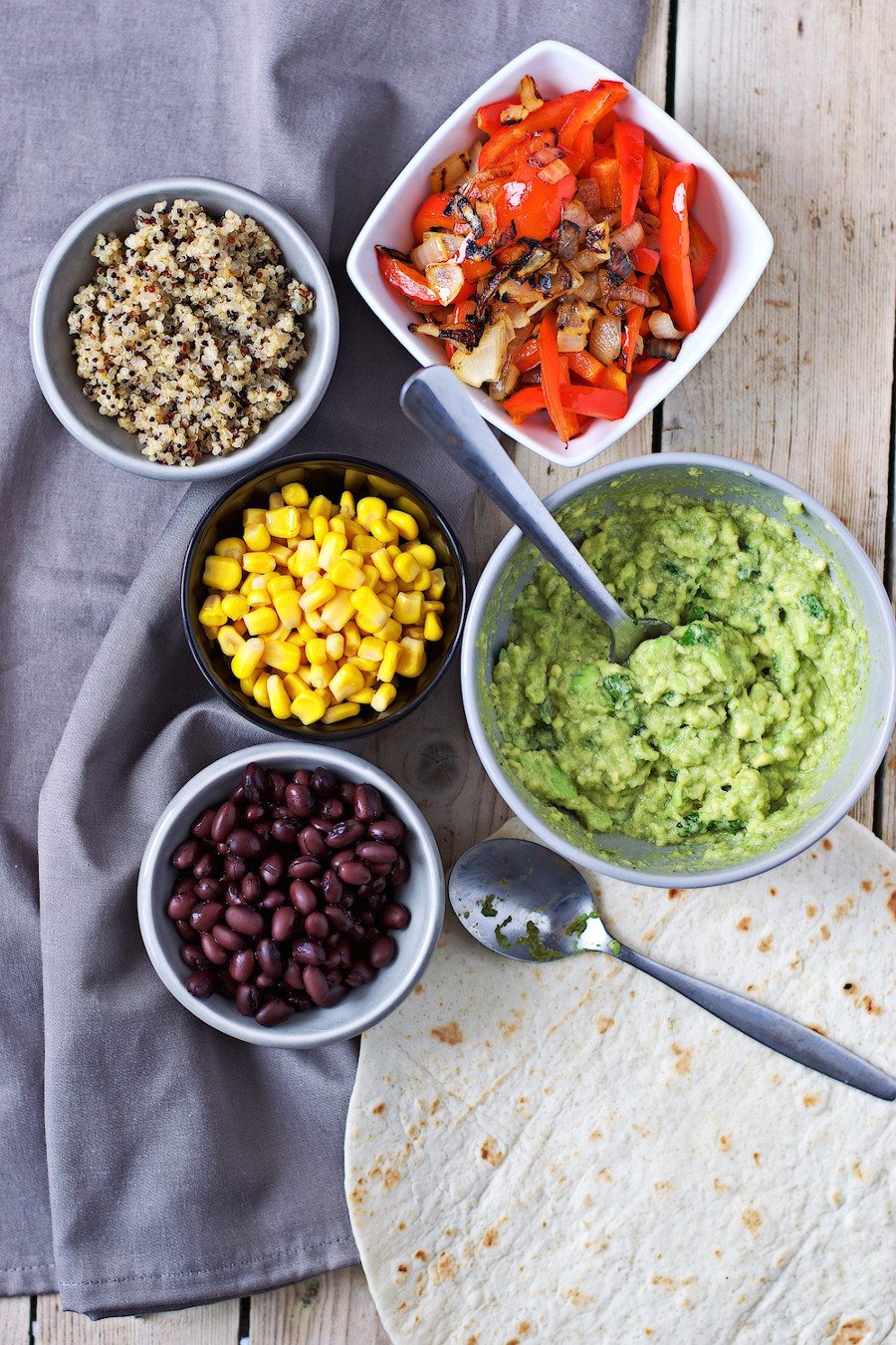 Top view on a collection of all ingredients needed to make Mexican Quinoa Wraps