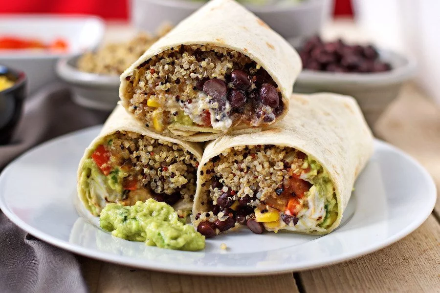 A stack of three Mexican Quinoa Wraps shown from the side, revealing the filling.