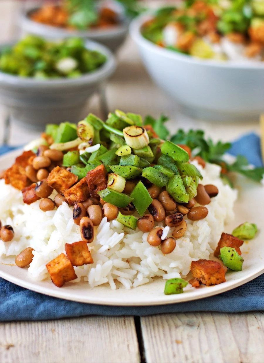 Closeup on the plate with Vegan Hoppin John showing the crunchy vegetables on a bed of rice.