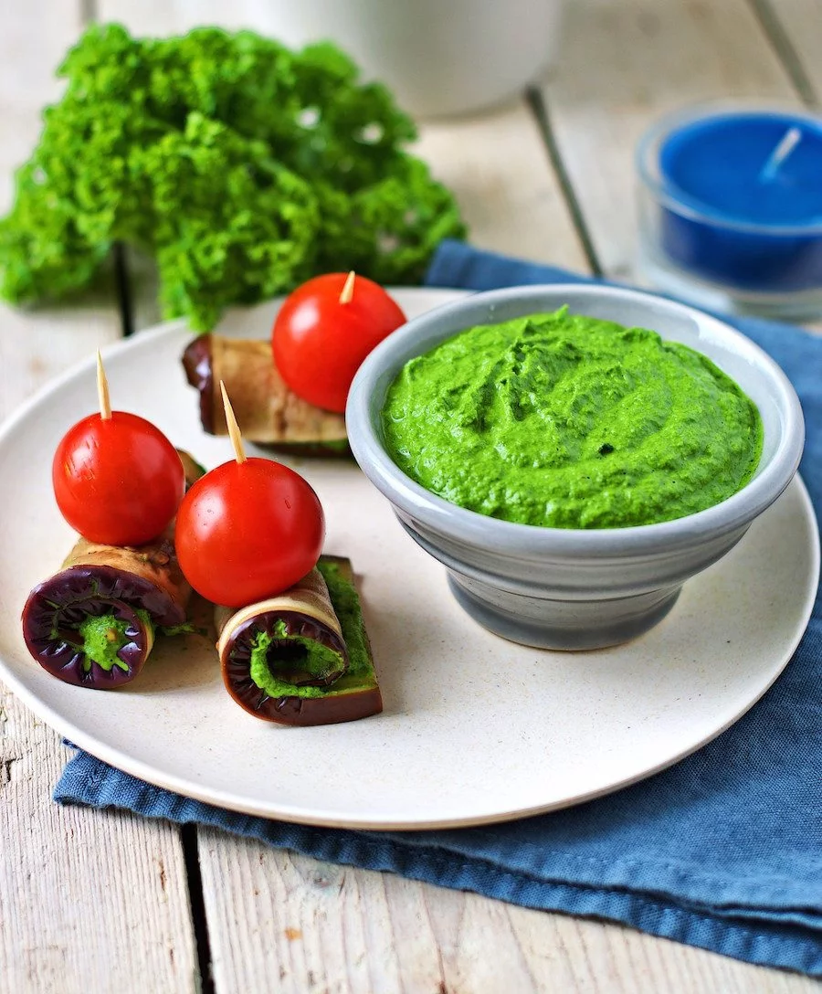 Kale Pesto and fresh vegetables on a plate.