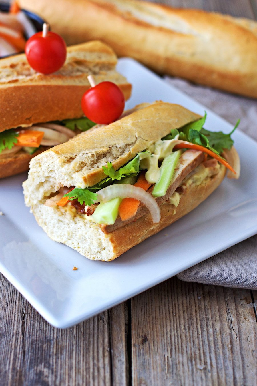 Two Vegan Banh Mi sandwiches on a plate.