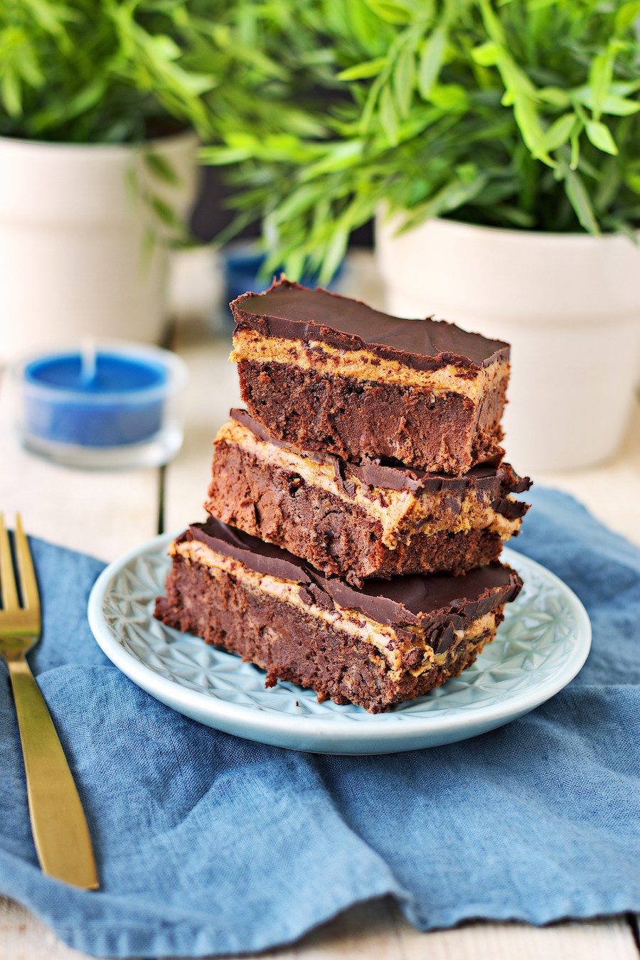A stack of three Vegan Buckeye Brownies on a small plate.