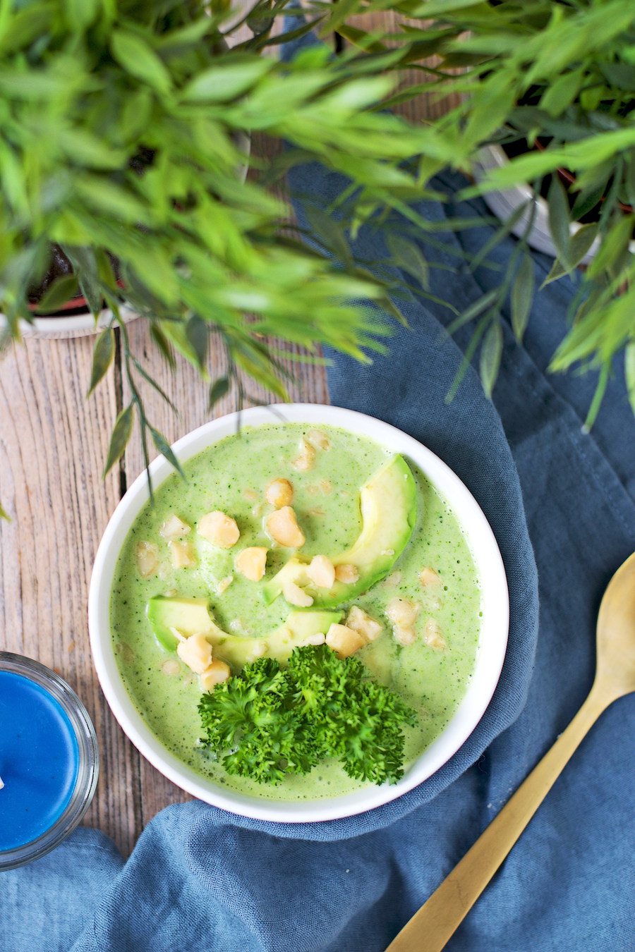 Closeup on the Detox Broccoli Soup showing parsley and avocado slices.