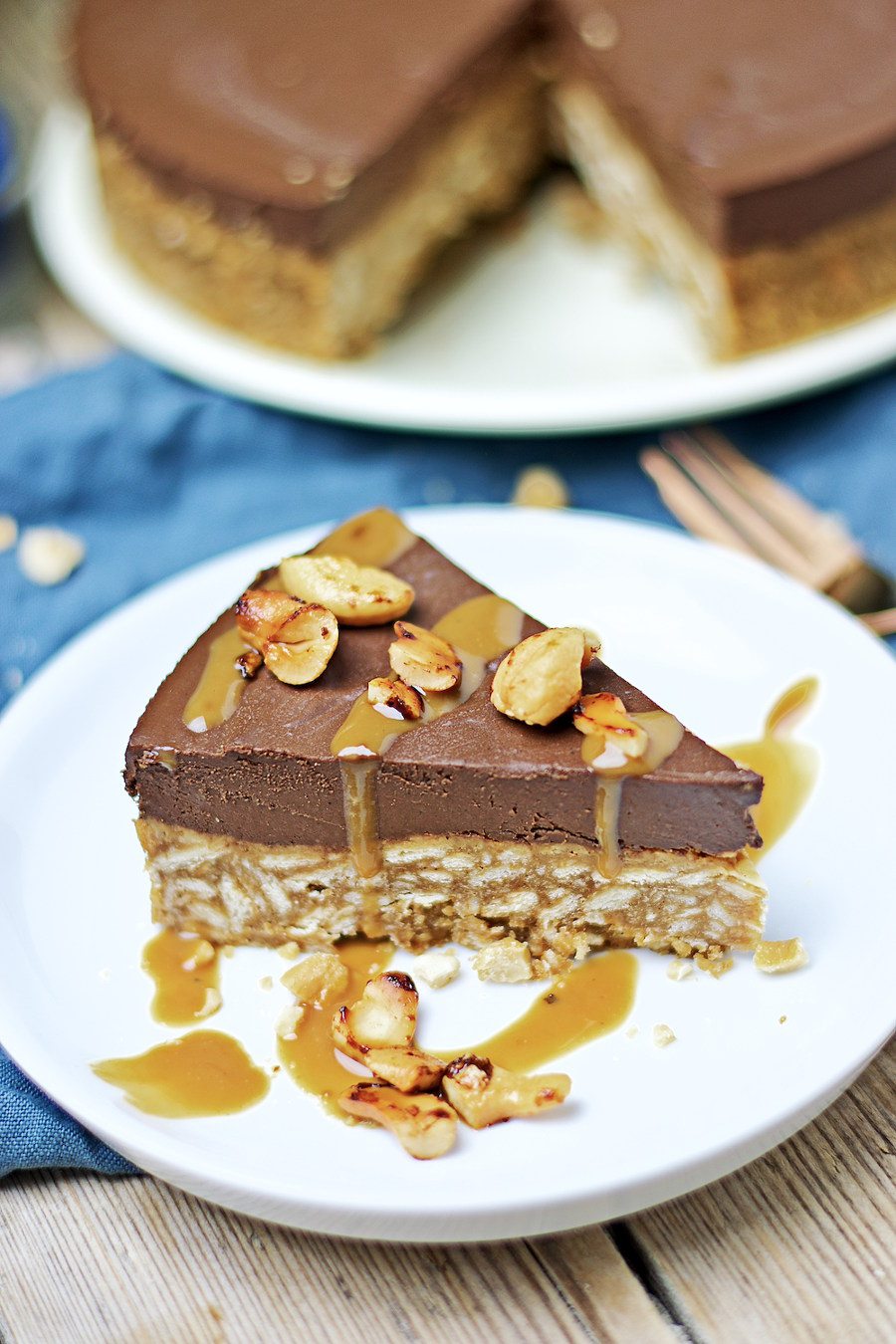 Near view focusing on the roasted cashews and caramel sauce as topping of the Vegan Chocolate Cake