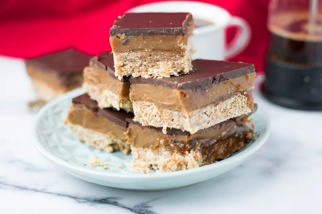 Side view closeup on the Vegan Caramel Shortbread (Copycat Twix Style) showing he individual layers.