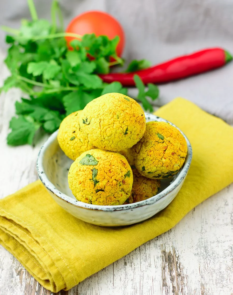 Small bowl with five turmeric falafel balls.