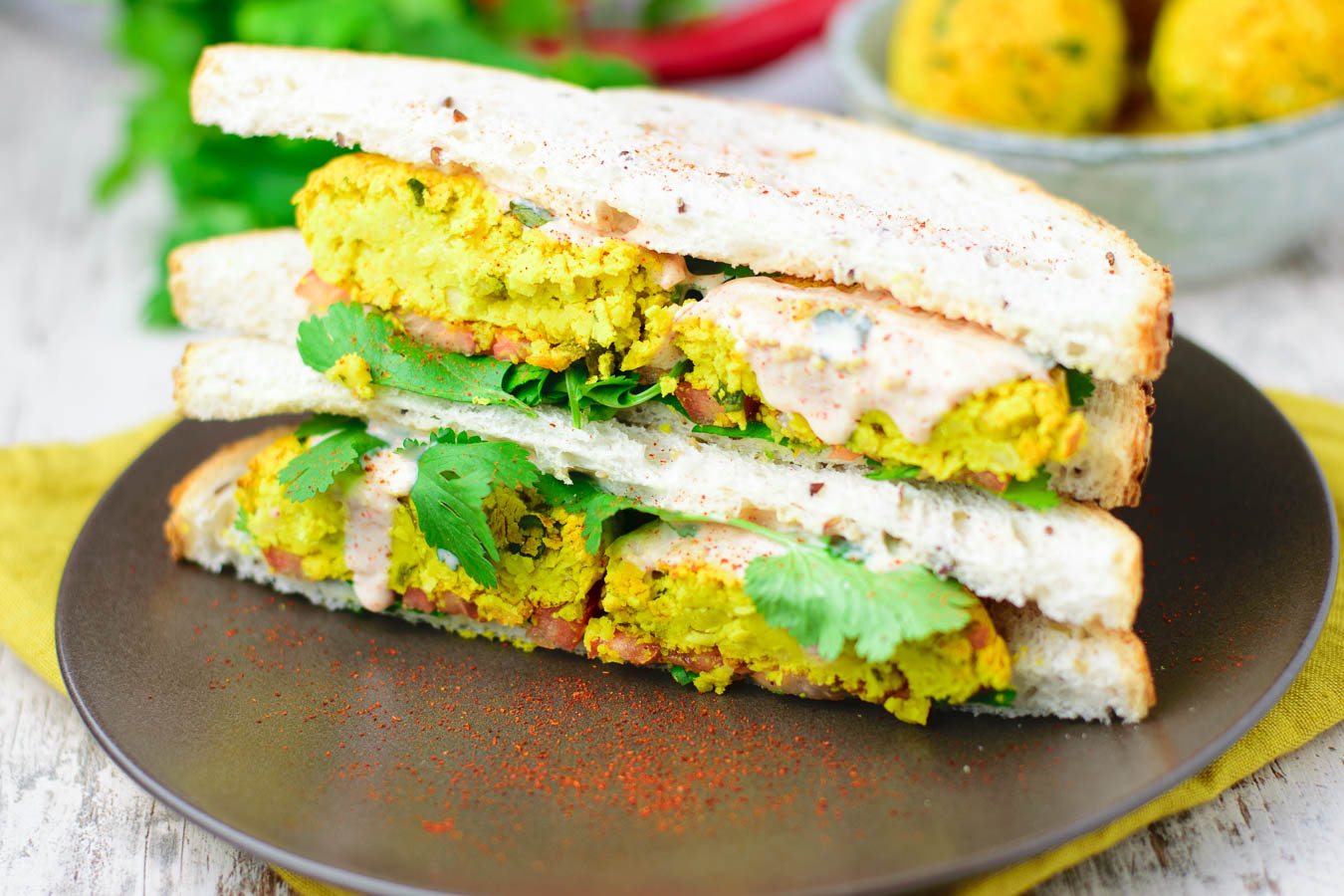 Closeup on a cut-open falafel sandwich.