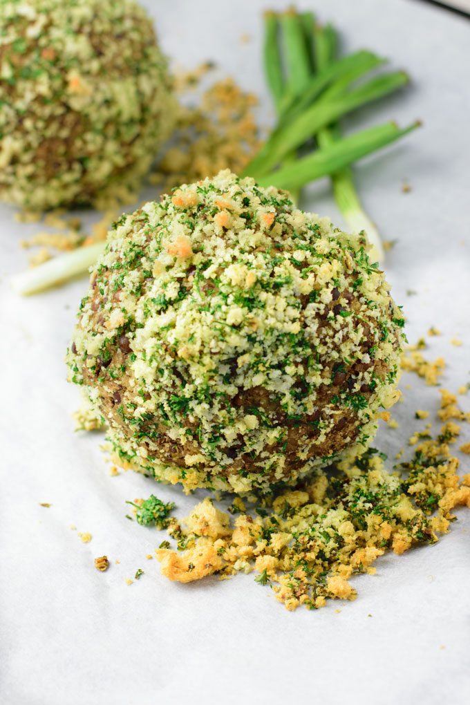 Closeup on a Scotch Egg Vegan Style before baking, covered in bread crumbs.