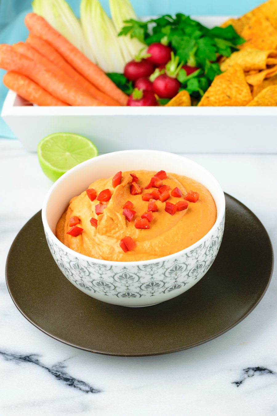 Bowl of the Easy Vegan Pimento Cheese garnished with diced bell pepper.