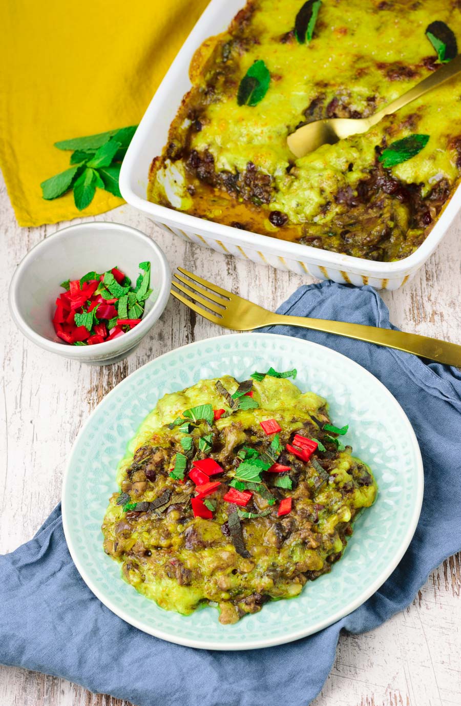 Plate of Vegan Bobotie with the casserole dish in the background.