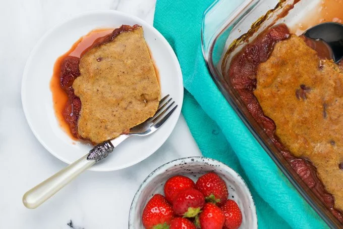 Top view on the Vegan Strawberry Cobbler on a plate and in the baking dish.