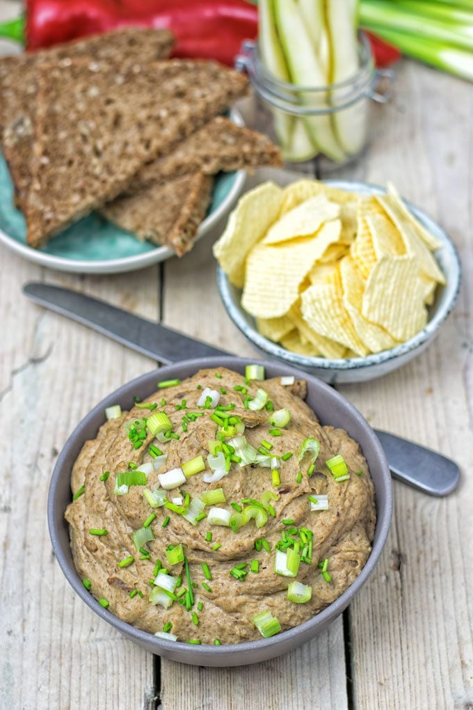 Vegan Pate with Lentils with potato chips and bread in the background.
