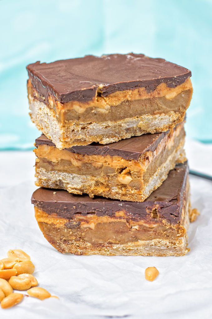 Closeup of a stack of three Vegan Snickers Bars.
