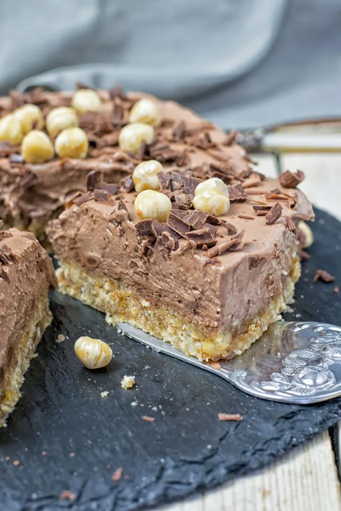 Closeup view on a slice of Nocciolato Hazelnut Cream Pie on a cake lift.