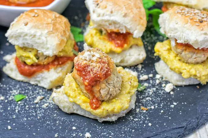 Several Marinara Meatball Subs arranged on a serving plate.