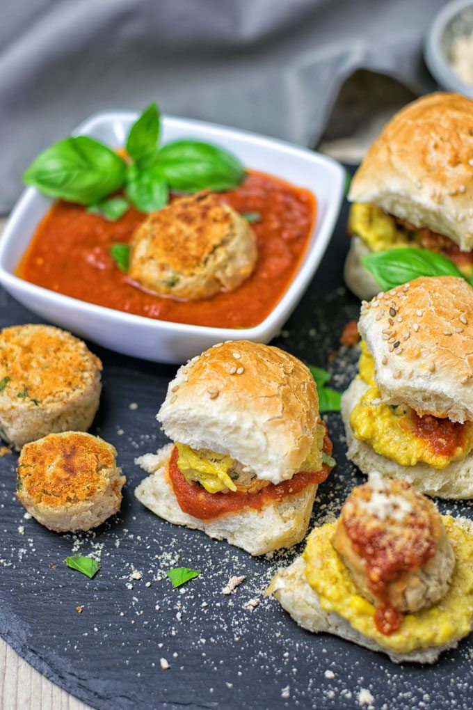 Marinara Meatball Subs with a meatball in extra marinara in the background.