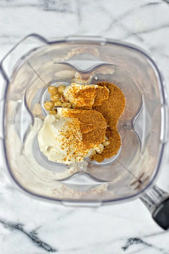 View into a blender bowl with the Coffee Cheesecake Mousse ingredients.