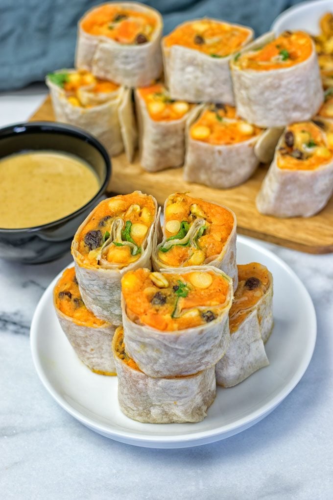 Closeup on a stack of Thai Green Curry Samosa Pinwheels on a plate.