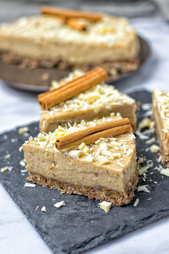 Several slices of the Cinnamon White Chocolate Cheesecake on serving plates.