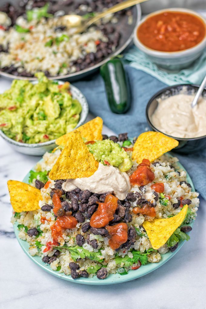 A serving of the Mexican Fiesta Cauliflower Rice with chips on a plate.