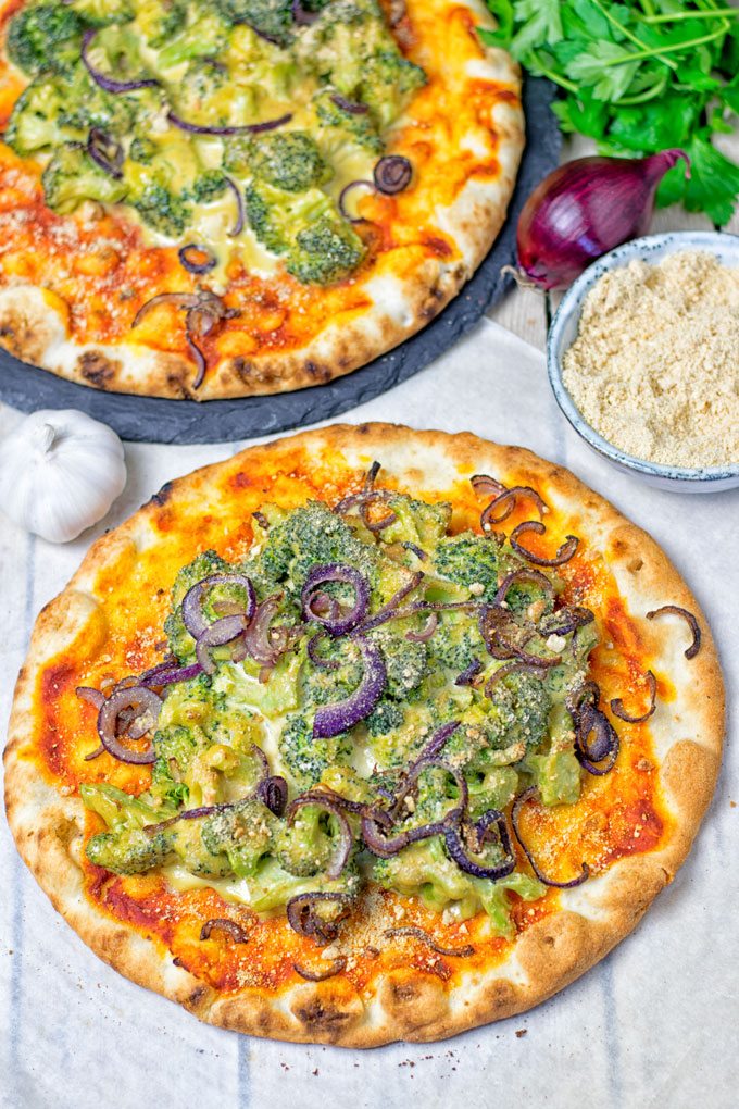 A single Broccoli Cheese Vegan Pizza on parchment paper.