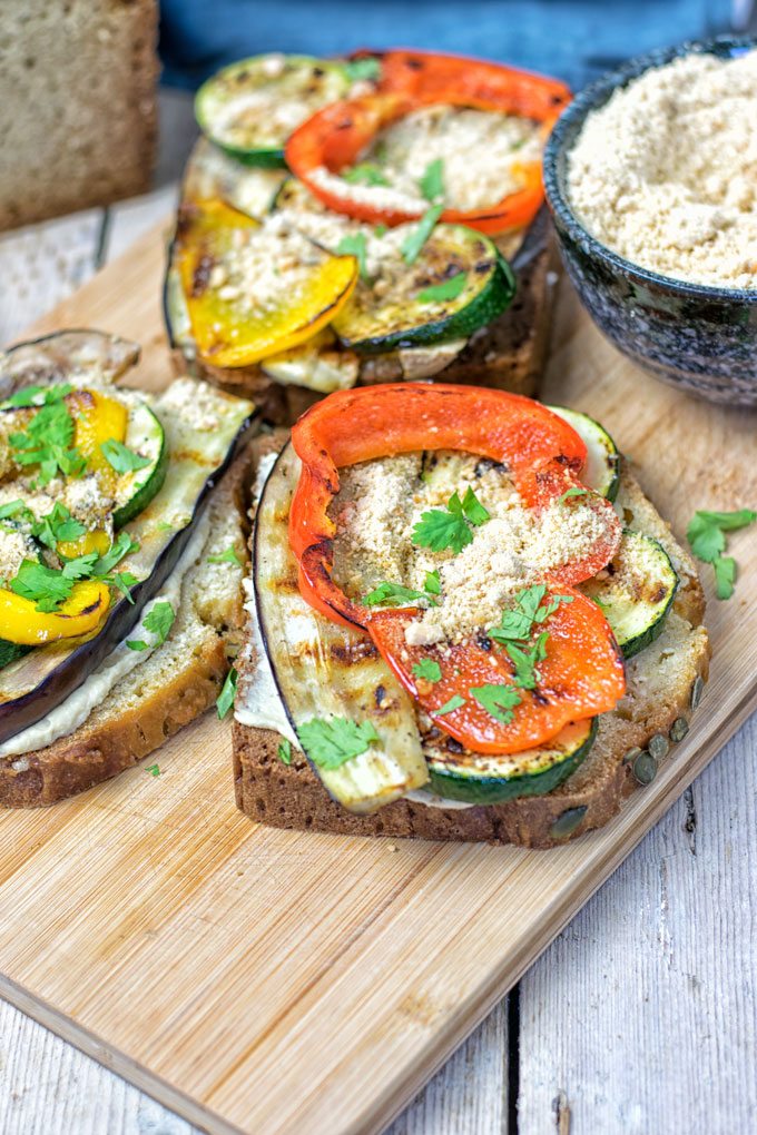 Closeup on several open Hummus Homemade Bread sandwiches.