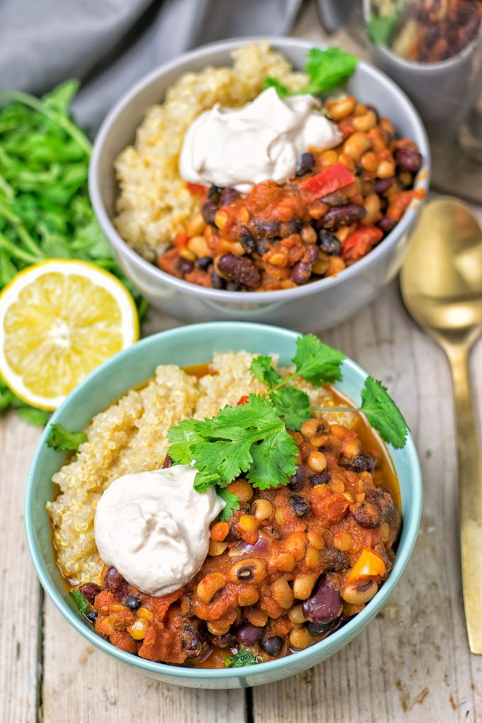 Two bowls of the Lentil Three Bean Chili served with a dollop of vegan sour cream.