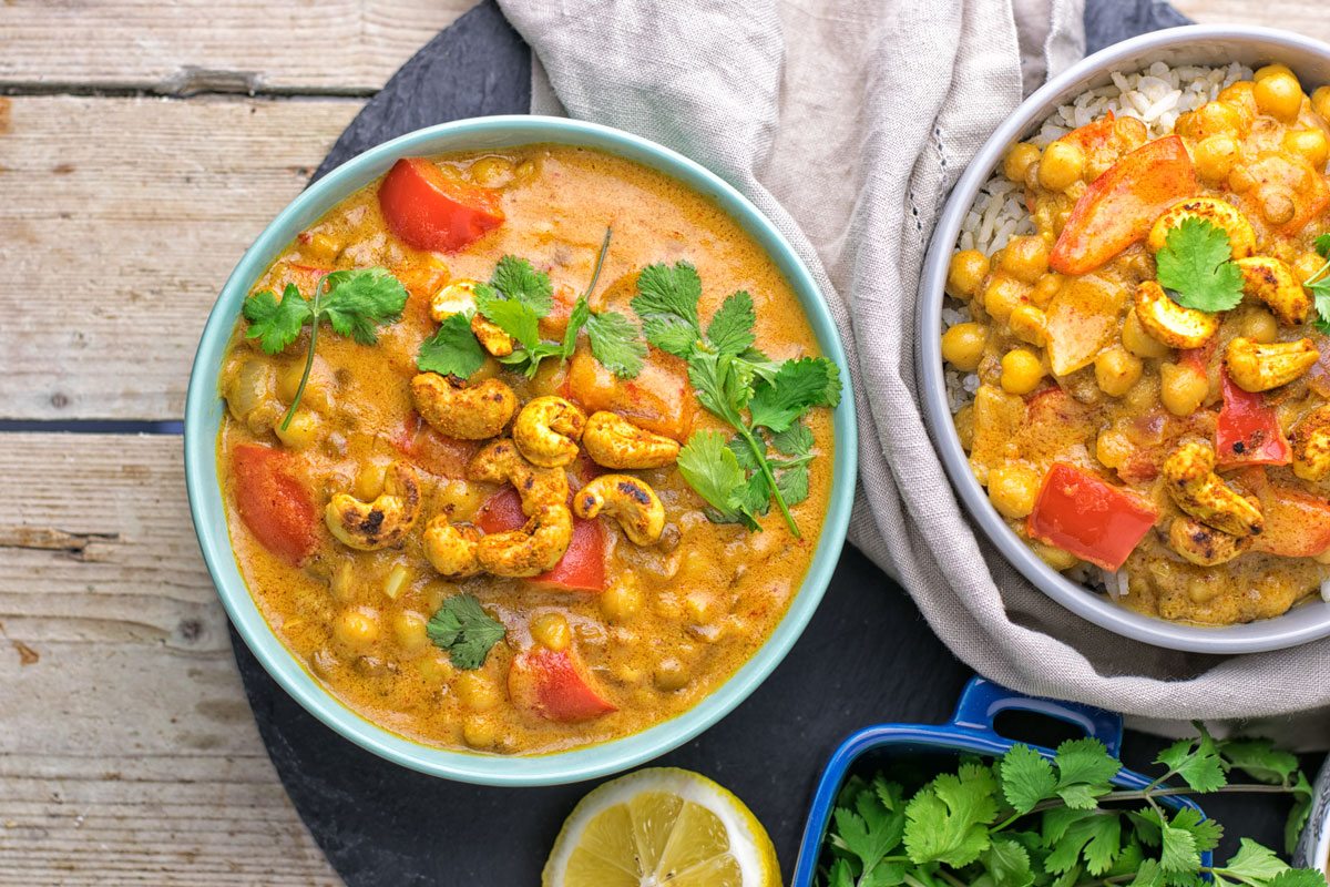 Top view on two bowls with Lentil Chickpea Yellow Curry.