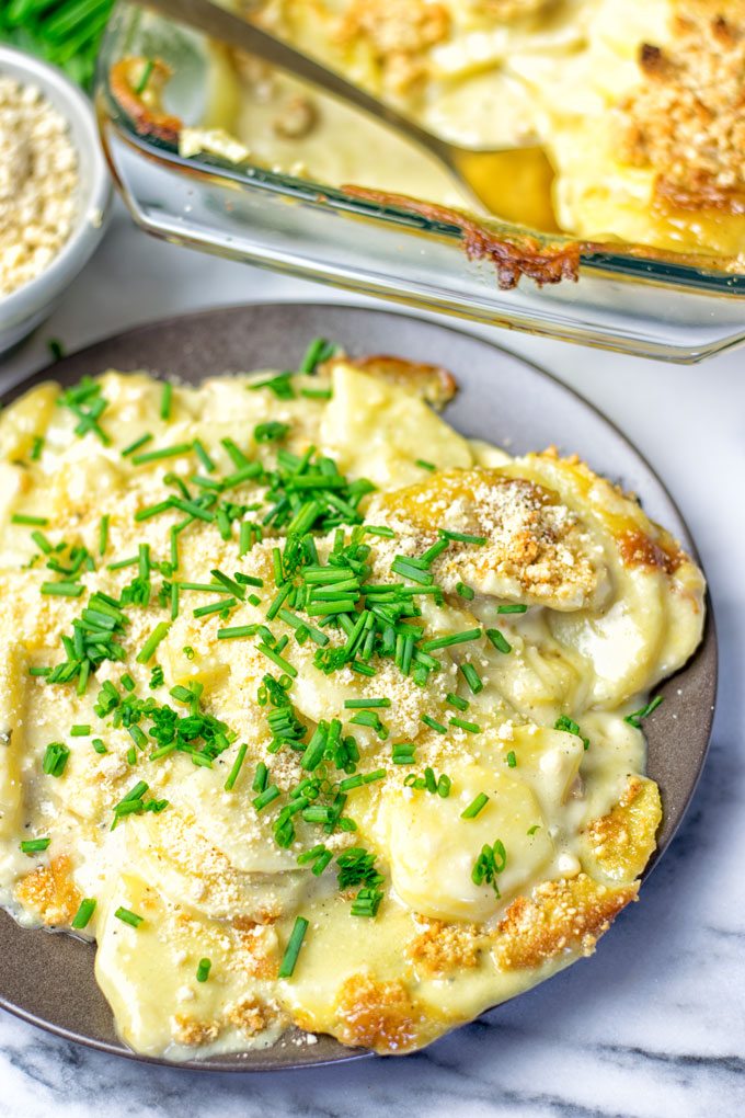 Portion of the Garlic Butter Scalloped Potatoes on a large brown plate.