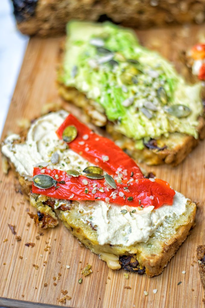 A slice of the Sun Dried Tomato Garlic Bread with hummus spread.