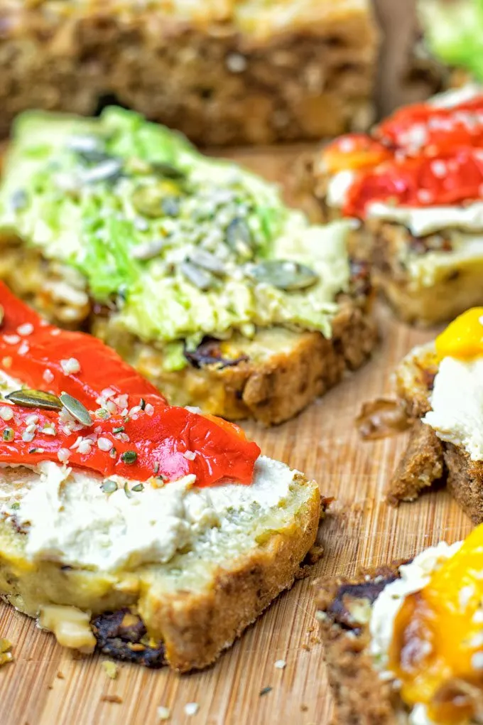 Sun Dried Tomato Garlic Bread slices on a wooden board.