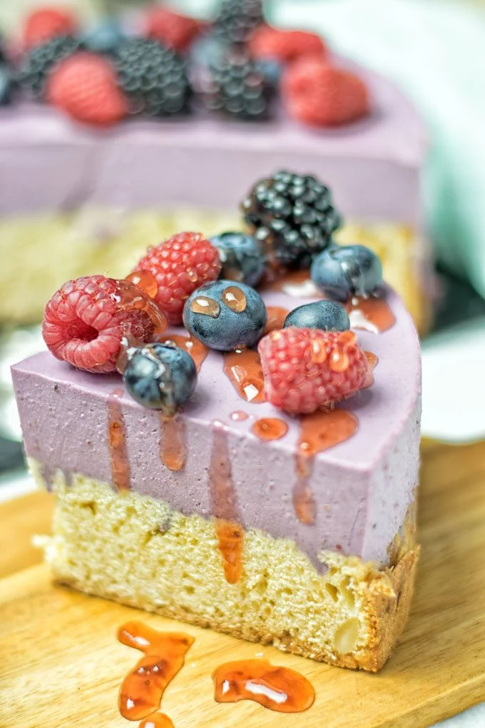 Slice of the Berry Smoothie Yoghurt Cake drizzled with extra sauce.