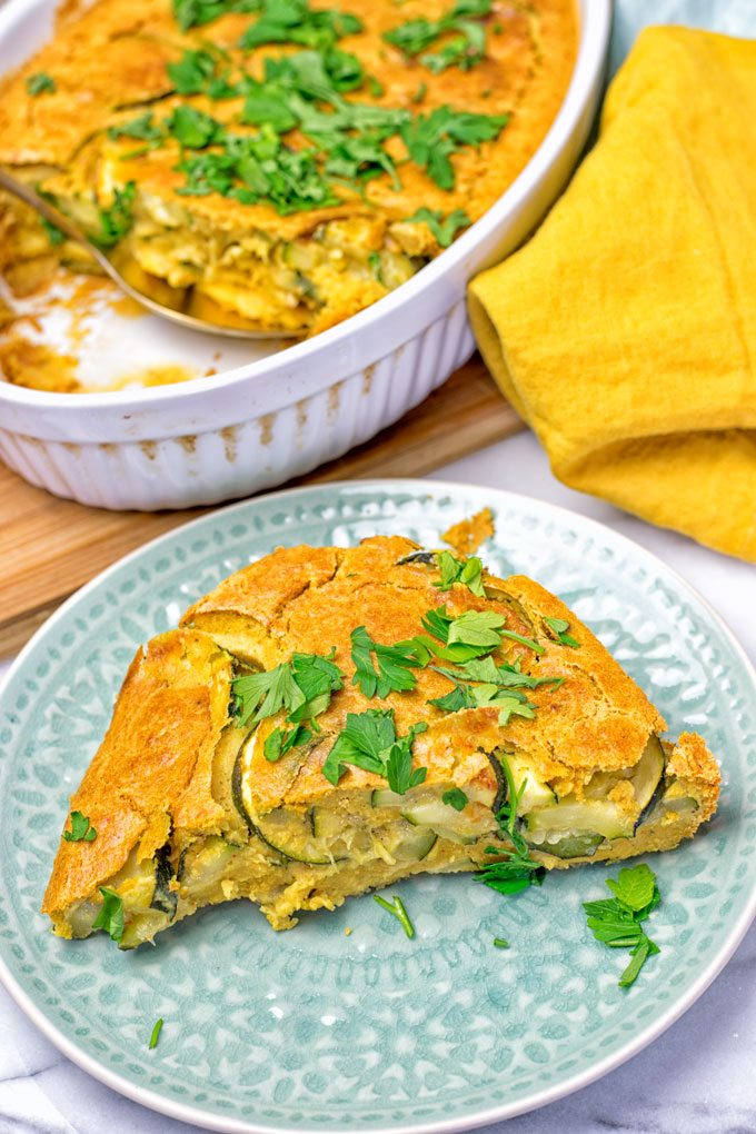 A slice of the Dairy-Free Zucchini Frittata on a blue plate.