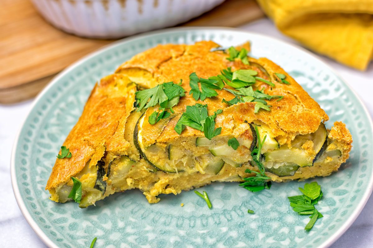 Portion of the Dairy-Free Zucchini Frittata is lifted from the baking dish.