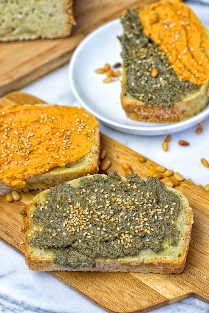 Two slices of the Garlic Butter Avocado Bread with different spreads.