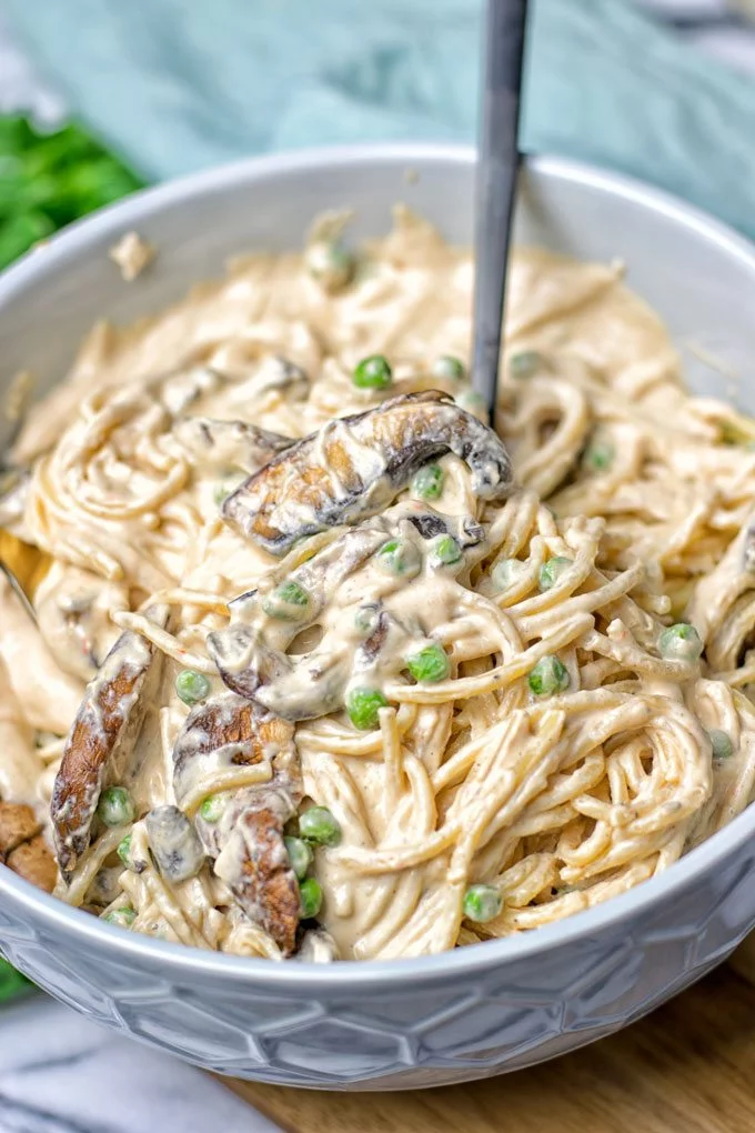 A large bowl with pasta mixed in the bowl.