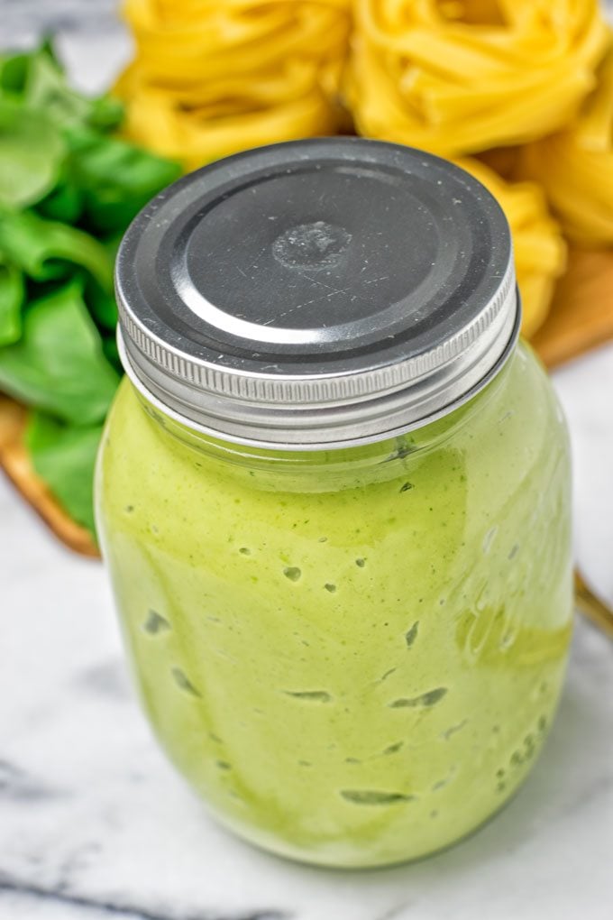 Avocado Pesto Pasta Sauce in a closed jar.