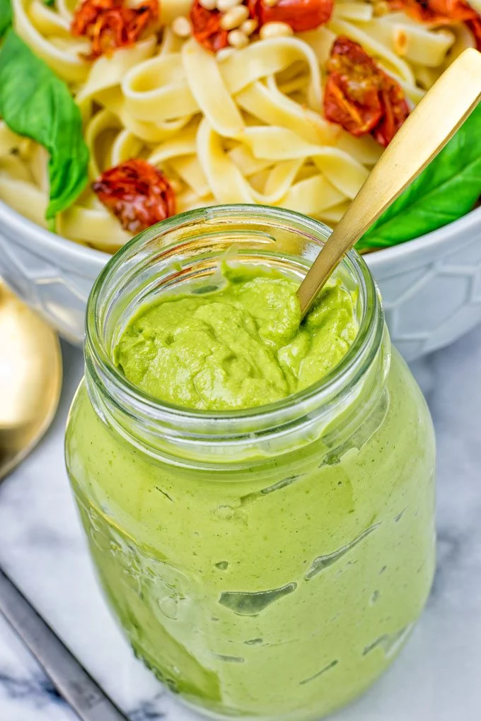 Golden spoon in the Avocado Pesto Pasta Sauce jar.