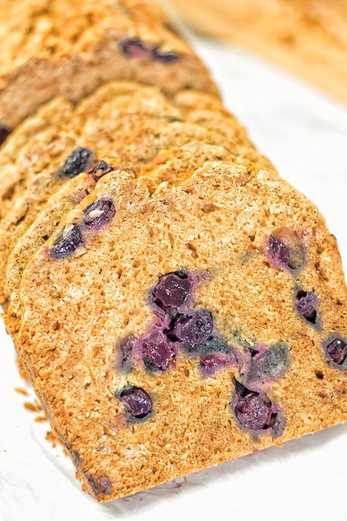 Open slices of the Gluten-Free Blueberry Bread with juicy blueberries.