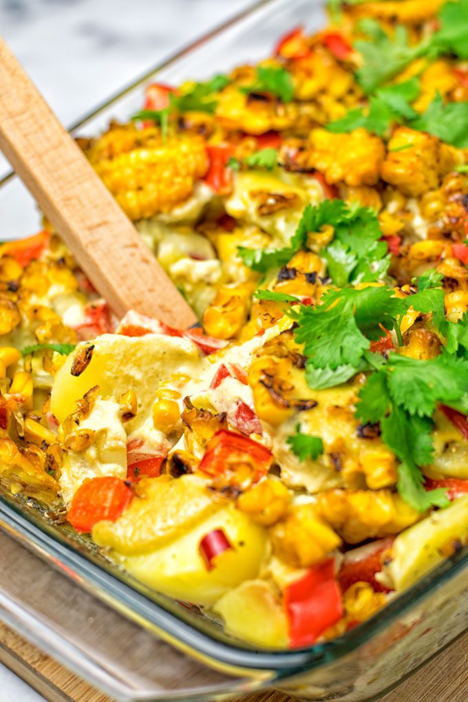 A portion of the Mexican Street Corn Potato Casserole is lifted from the dish.