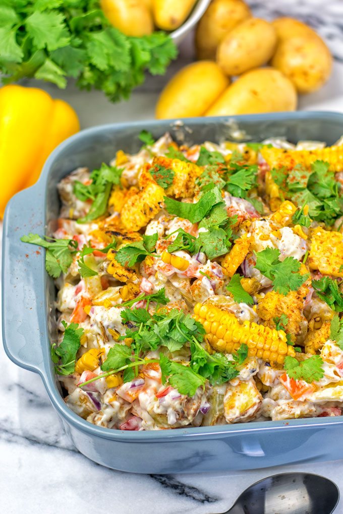 A dish filled with the Mexican Street Corn Potato Salad 