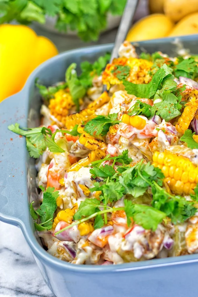 Black spoon in the Mexican Street Corn Potato Salad