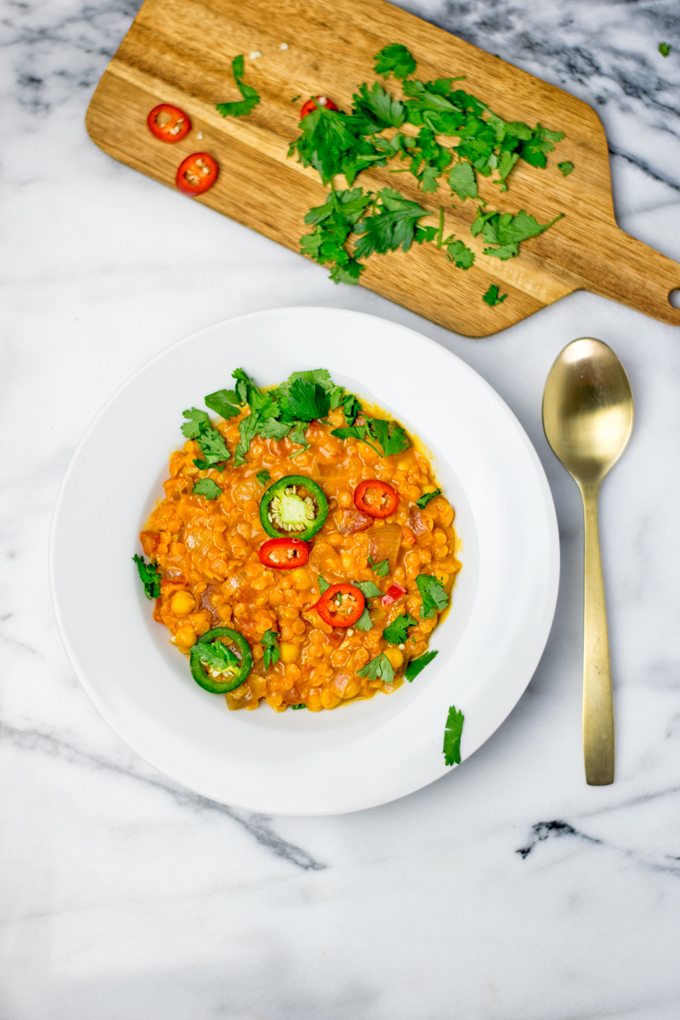 A portion of the Moroccan Chickpea Lentil Soup on a white plate.