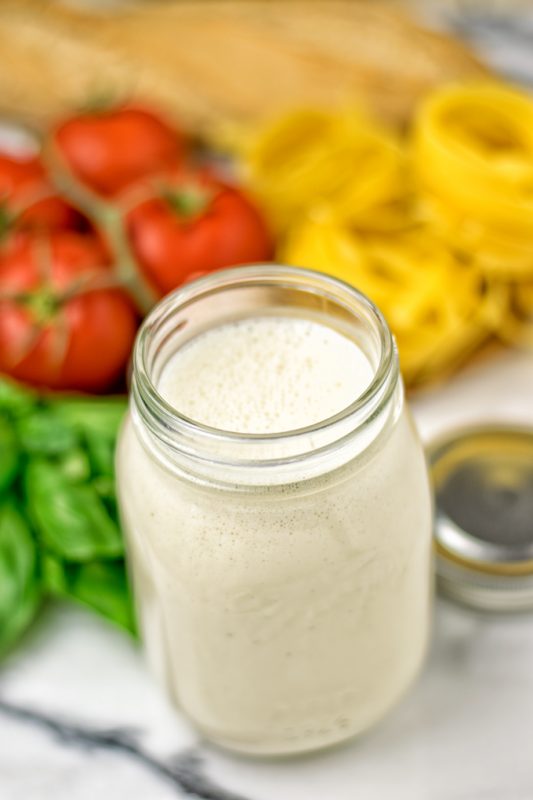 The Roasted Garlic Carbonara Sauce in a glass jar. 