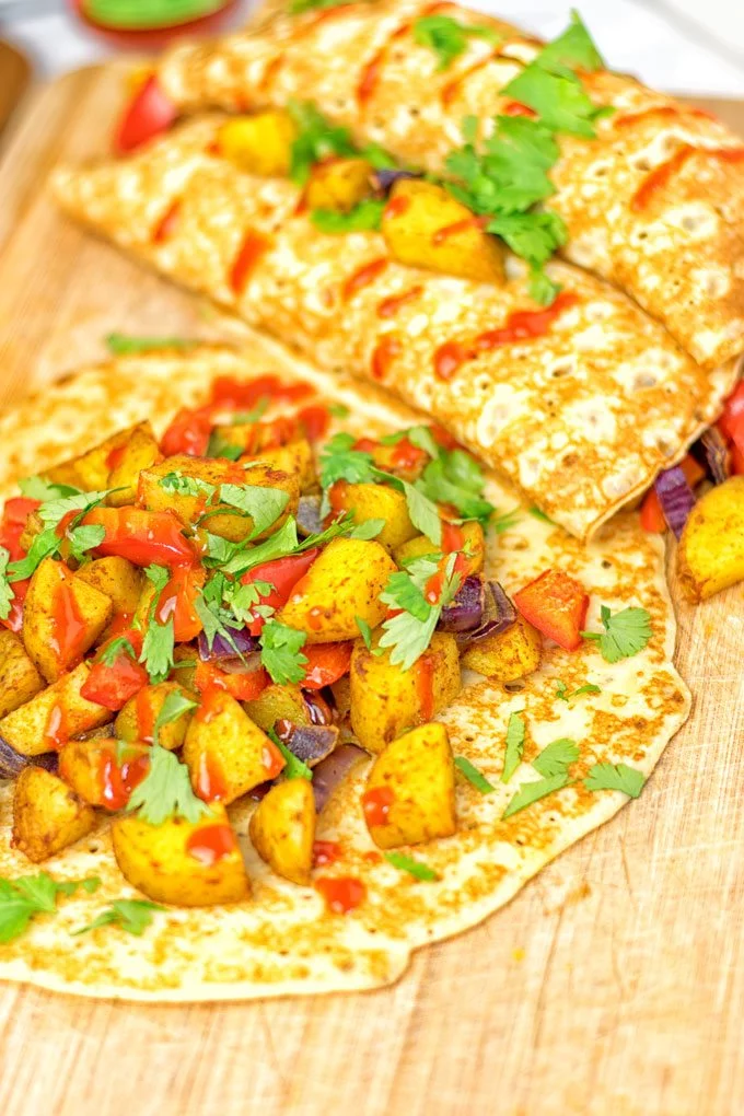 Garnishing the Spicy Potato Breakfast Pancakes with fresh cilantro.