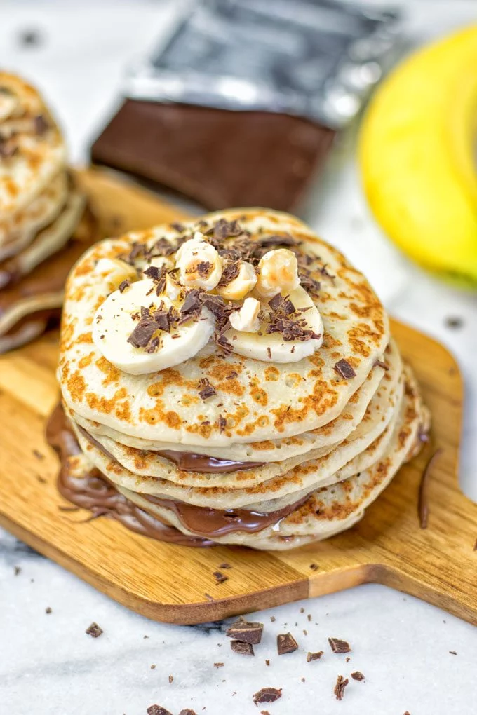 View of a pancake stack on a wooden board.